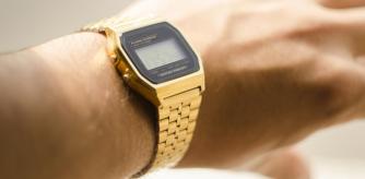 A gold Casio-style watch on a man's wrist