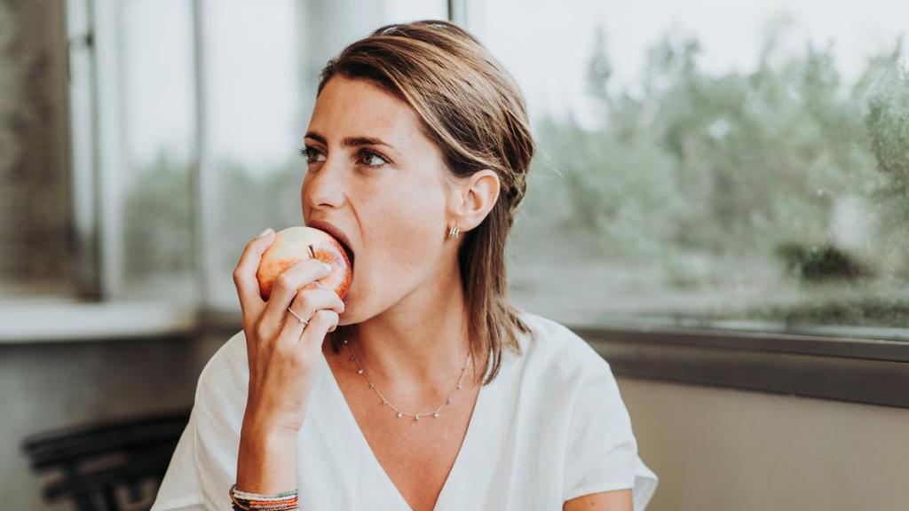 Woman eating an apple.