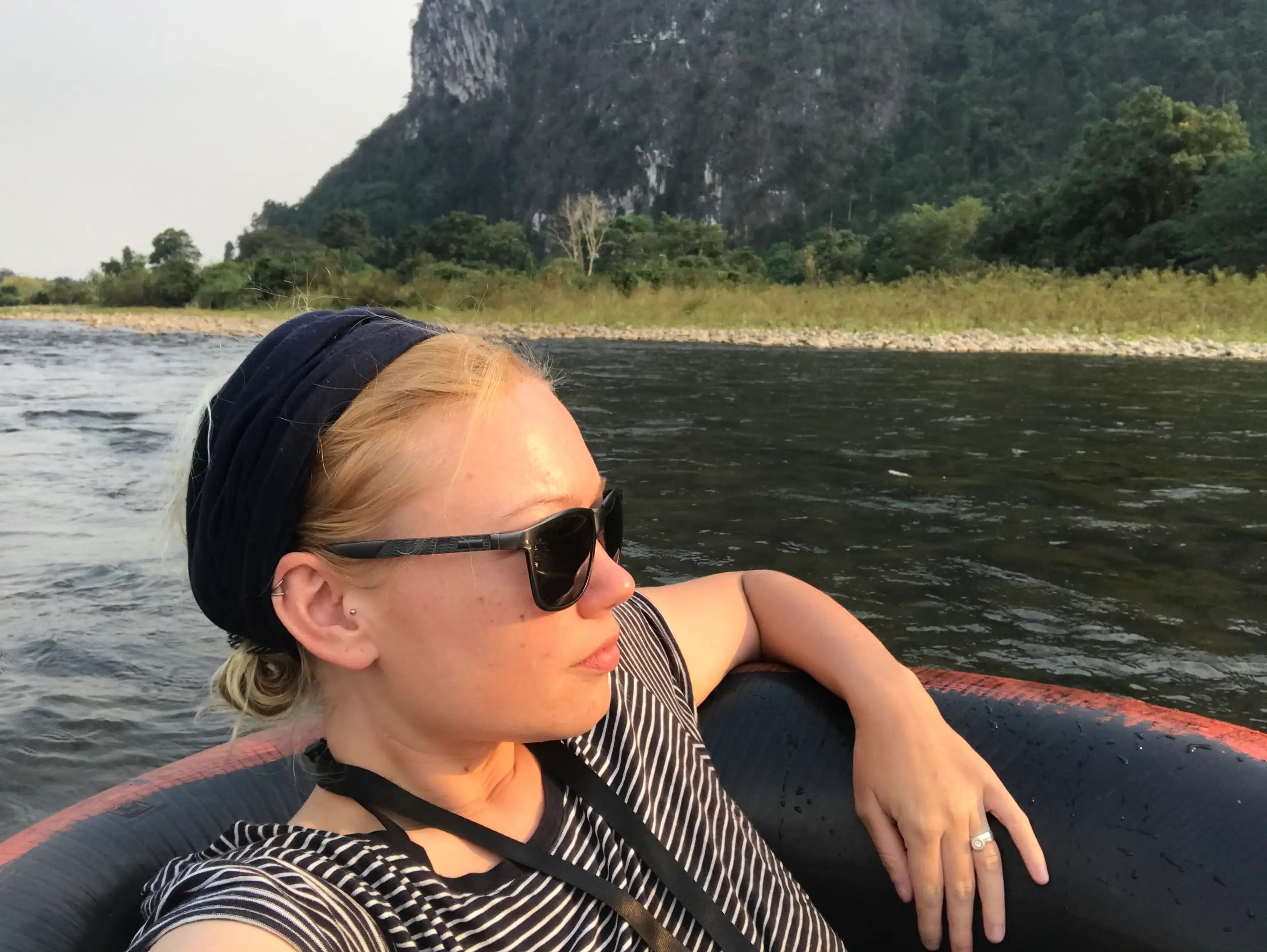 Jennifer Sizeland sitting in an inner tube floating down a river.