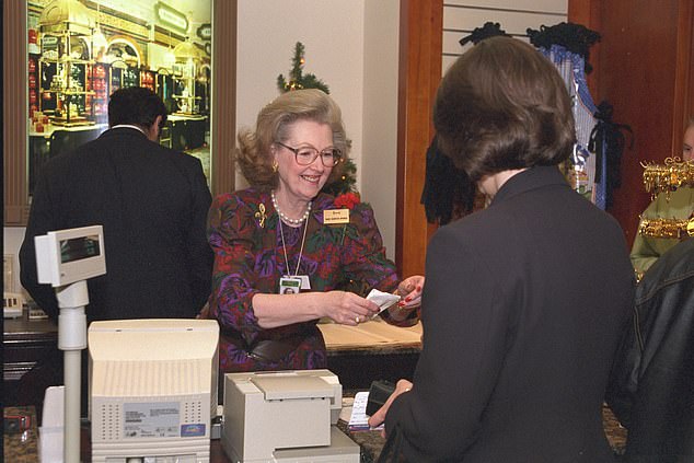 Raine serves a customer in Harrods Heathrow store in 1997