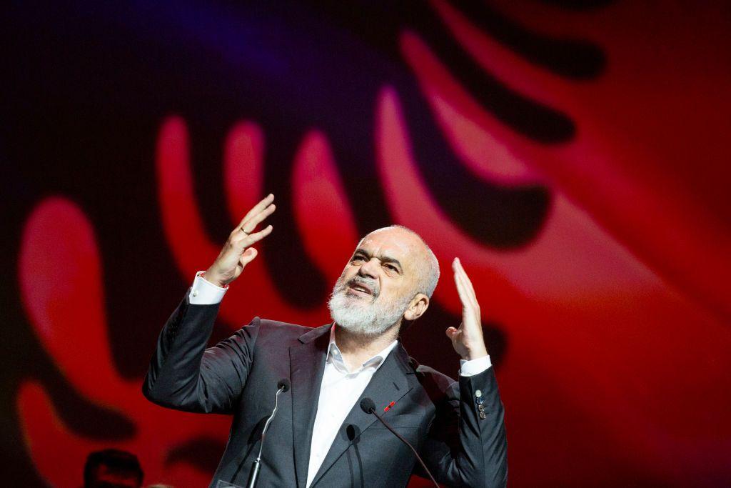 Edi Rama giving a speech with the Albanian flag in the background